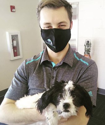 Landmark EPC employee holding a dog